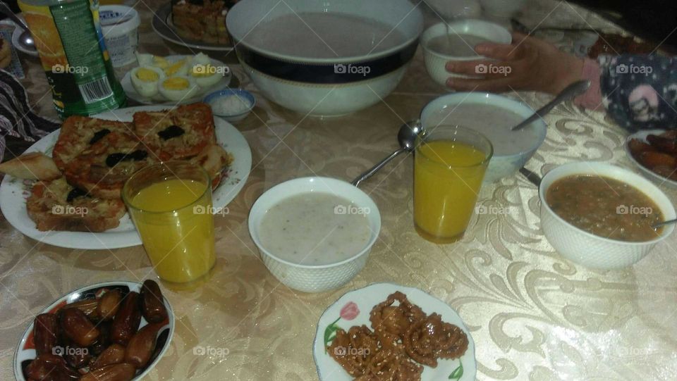 Moroccan table full of soup and juice.