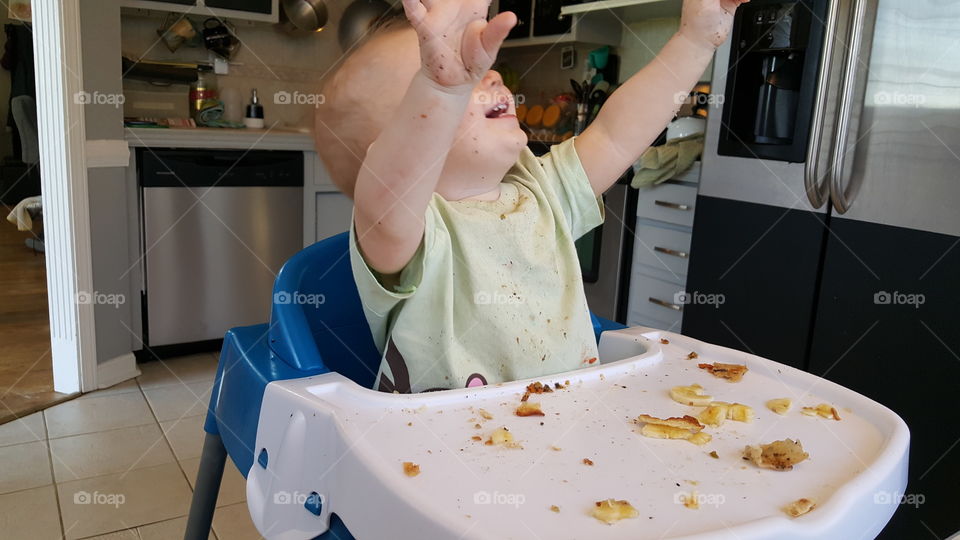 messy baby 1 year food eating natural setting at home kitchen family children child