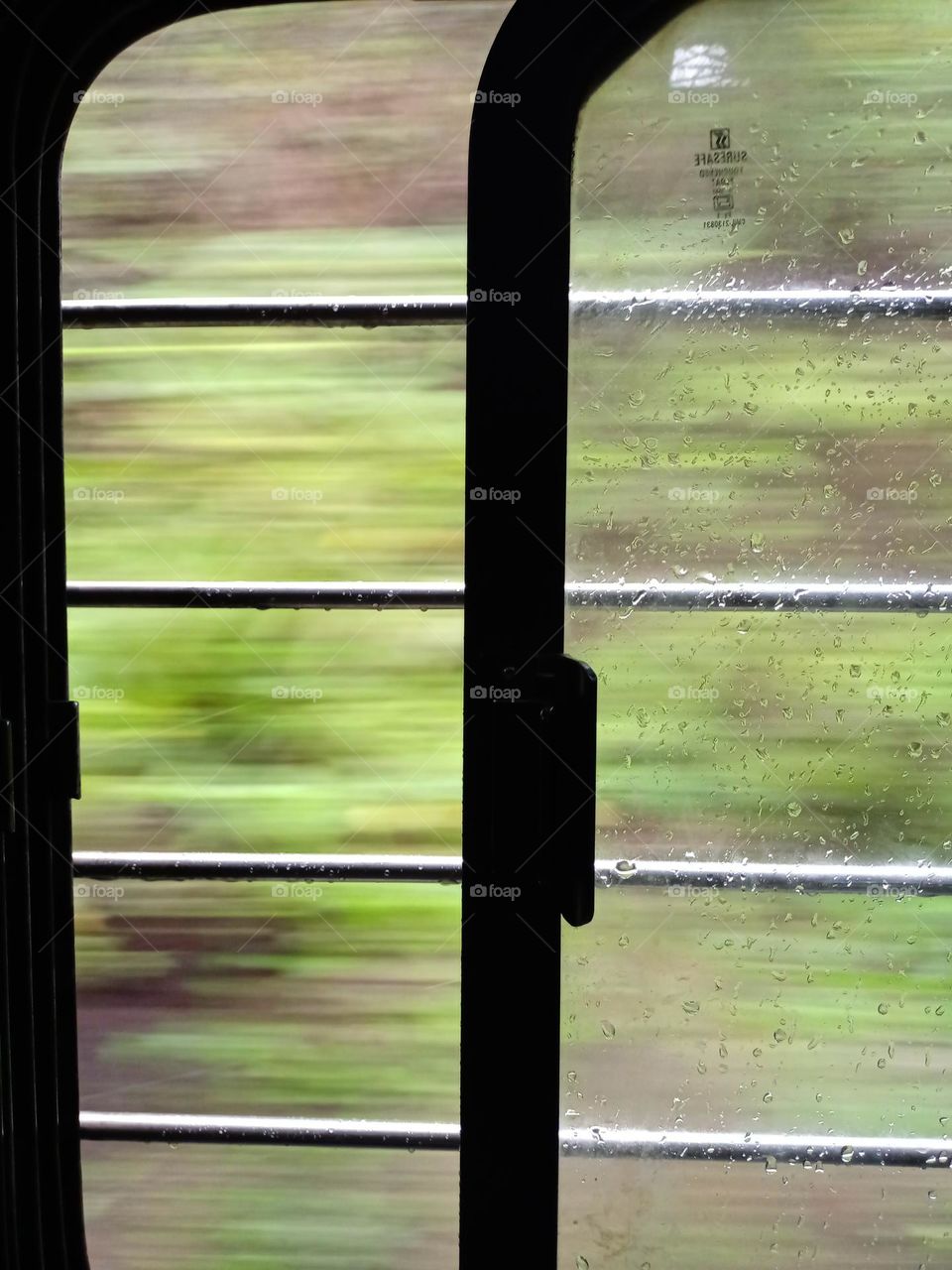 A simple view of the train window in journey with nice green background
