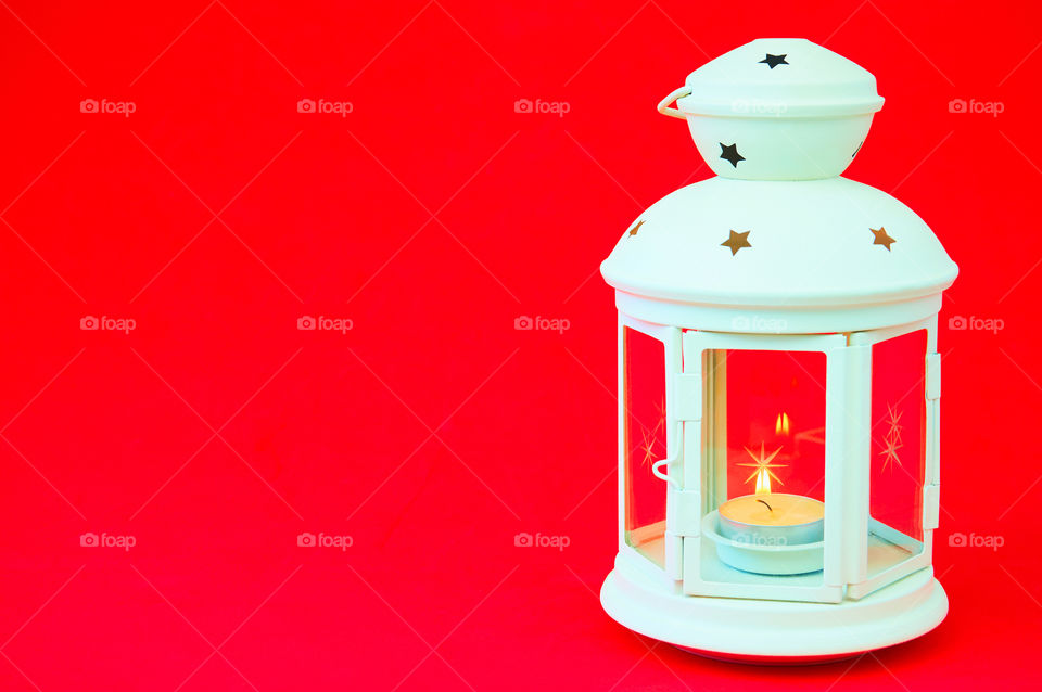 Lanterns with candle light on red background with copy space 