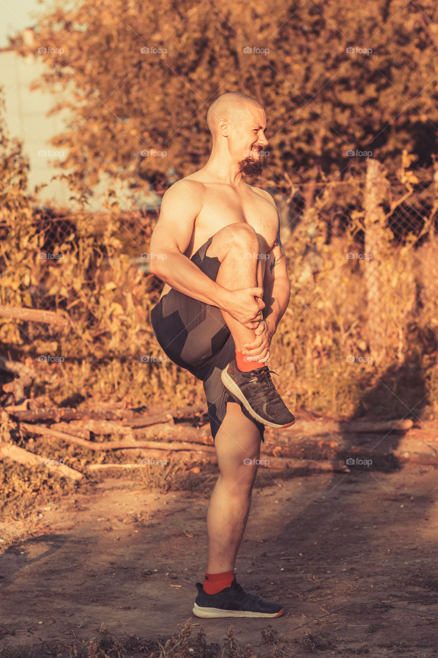 Young man have stretching moment in the evening light. Healthy lifestyle.