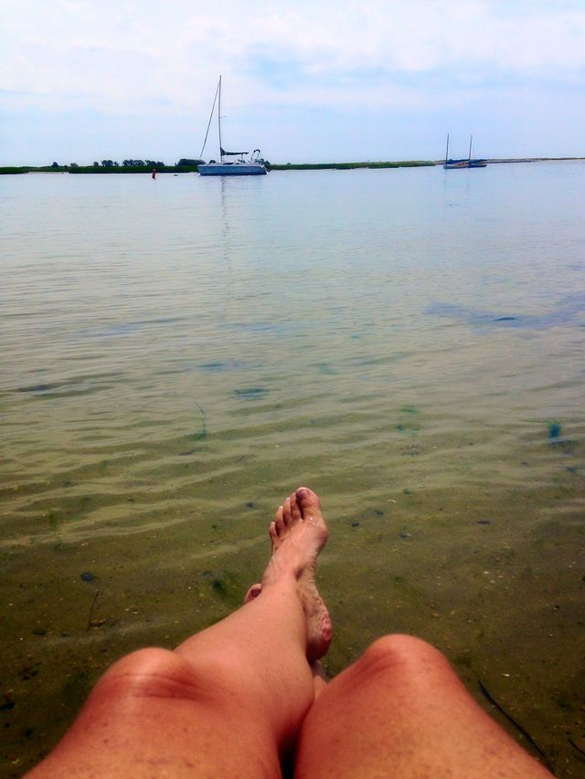 Scenic view. Hanging at the beach selfie - foot view mission 