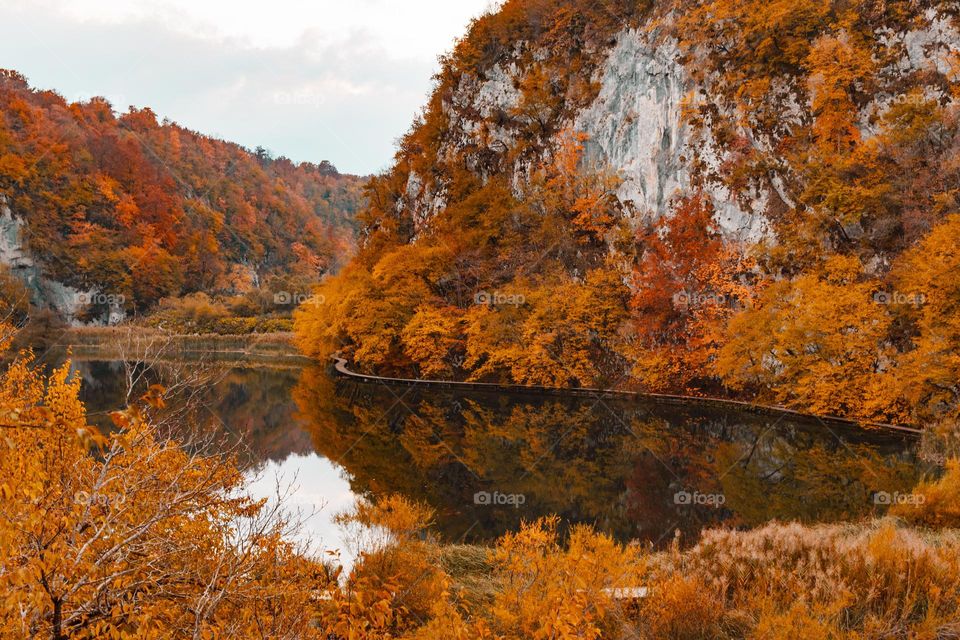 Beautiful autumn scenery with reflection of trees in lake