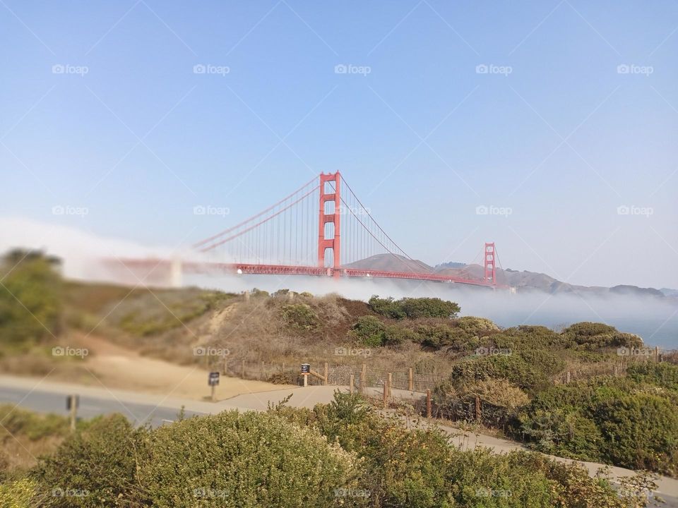 Landscape view of the fog rolling in across the Golden Gate bridge