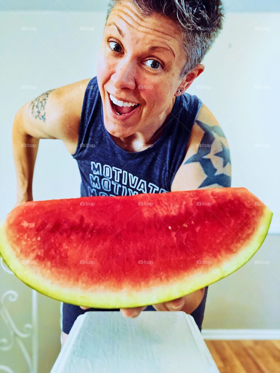 Watermelon and woman, juicy watermelon held by fit woman, summertime treats