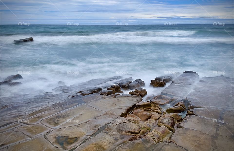 Waves over rocks. Merewether Beach, NSW Australia 