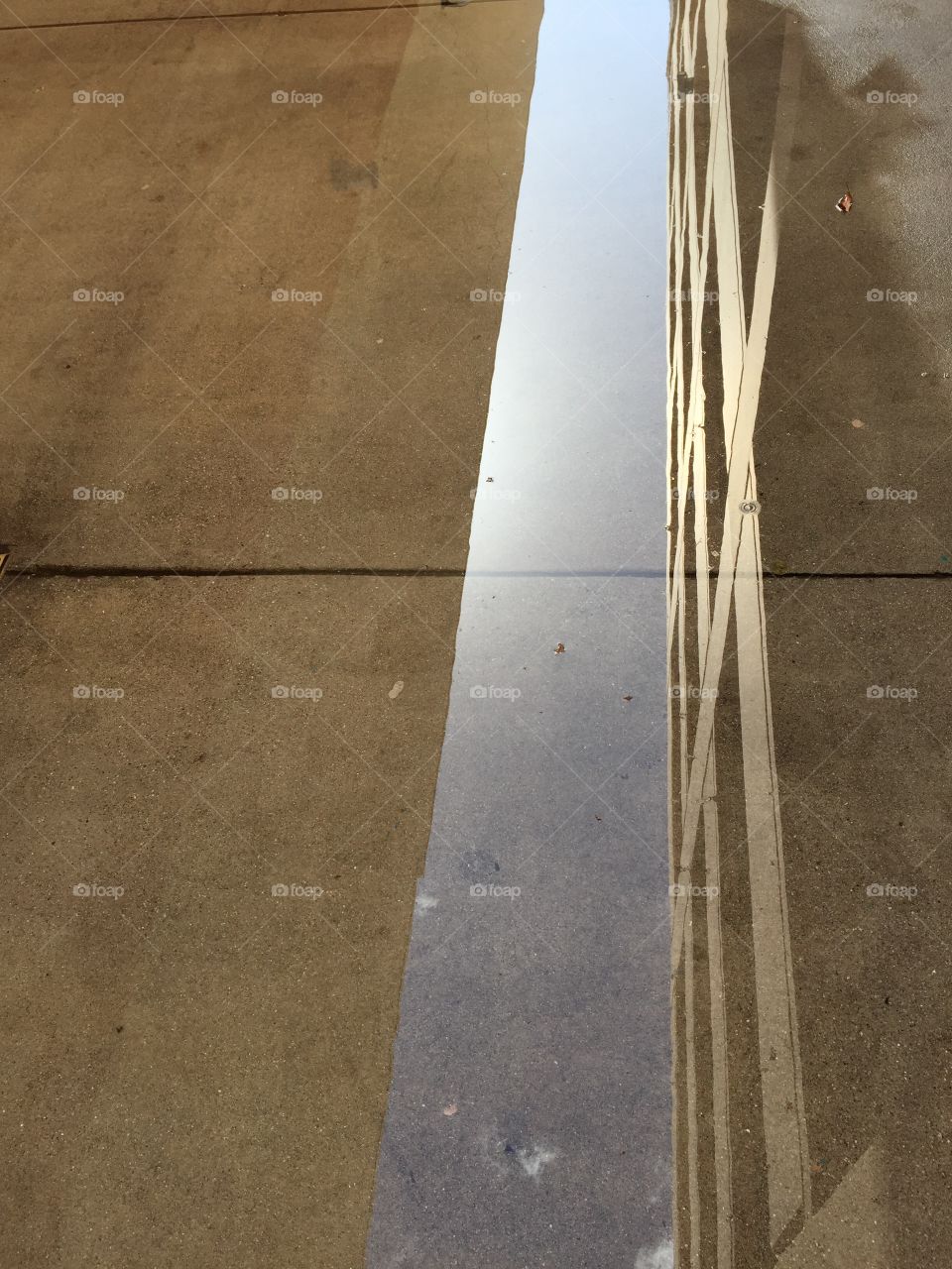 Buildings reflected in a puddle of water 