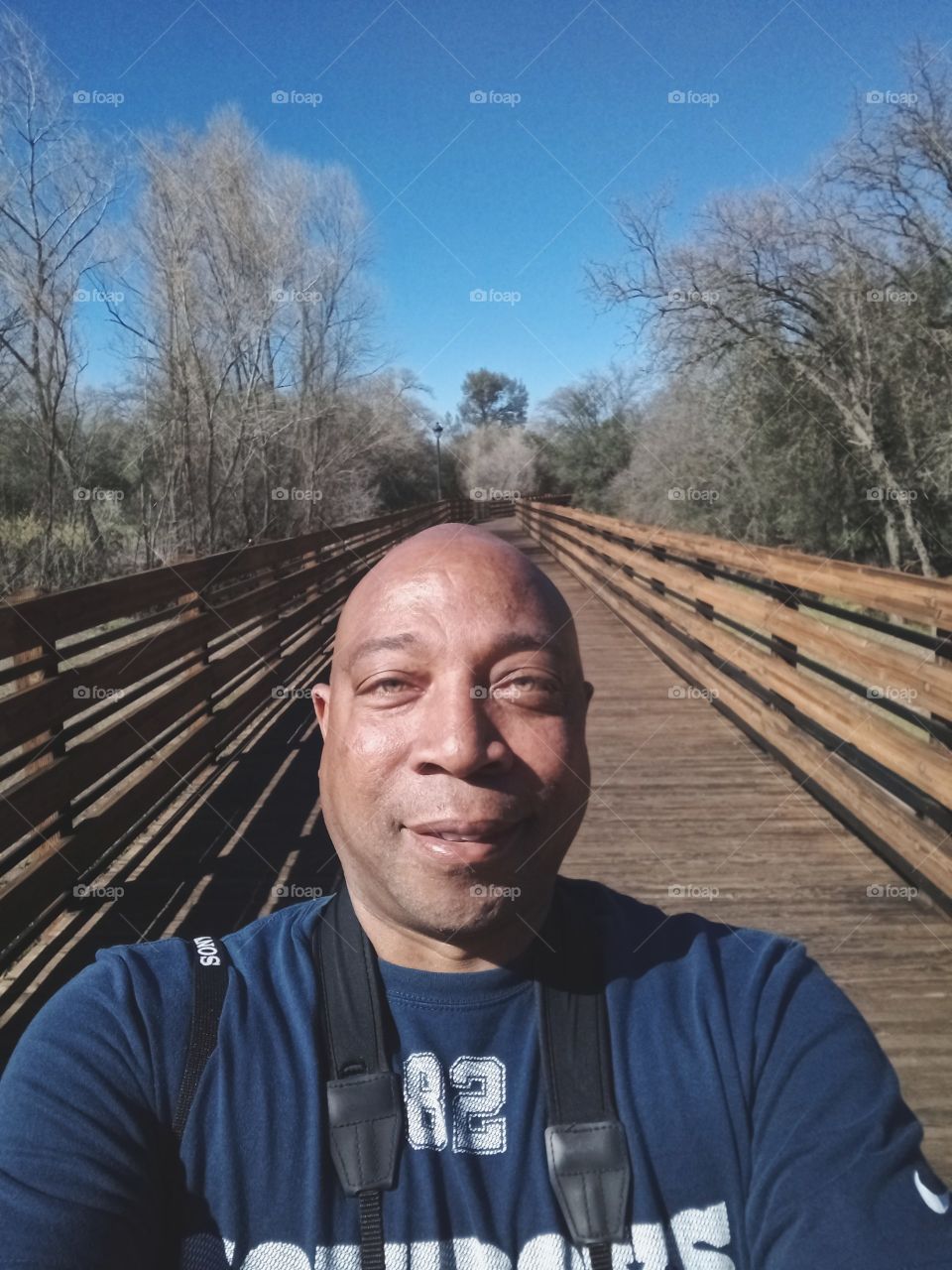 selfie pic nature hike across a footbridge