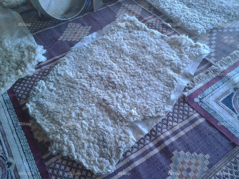 A small traditional mattress made of sheepskin leather