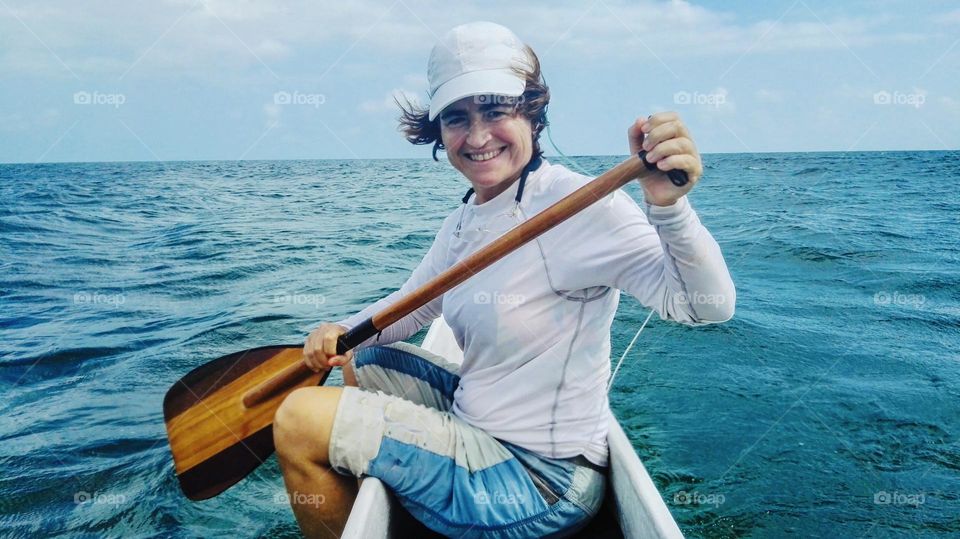 Woman with oak into the sea 