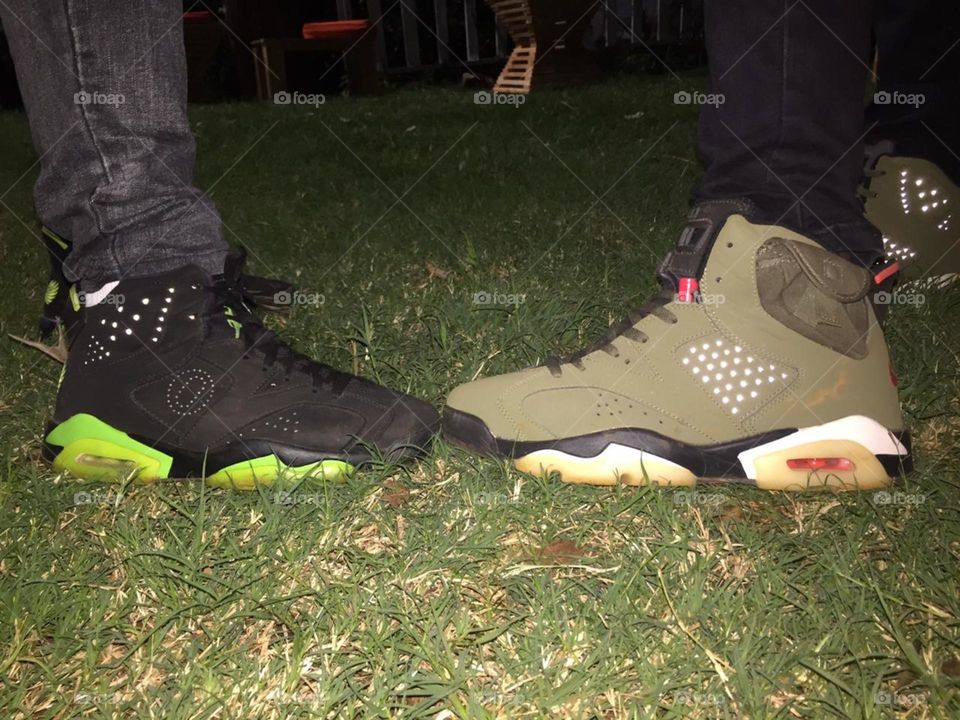 Two people, two unique types of shoes at the end of a long day.