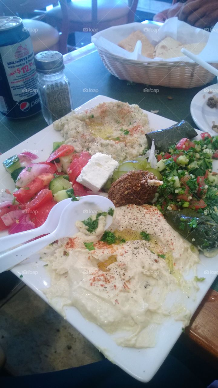Mediterranean fresh plate, with colorful crisp vegetables, hummus and falafel.  international cuisine.