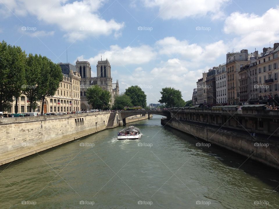View of Notre Dame de Paris from a bridge over the Seine. 