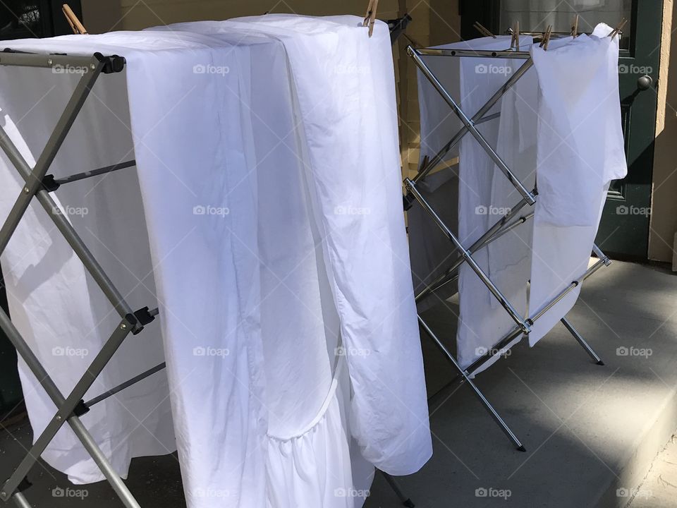 White sheets drying in the cool spring air