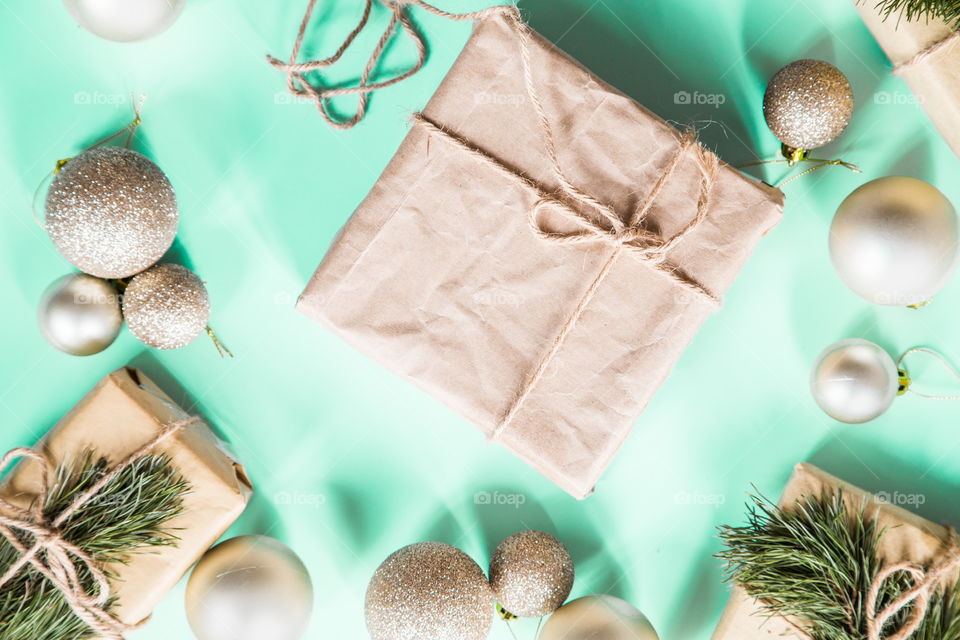 Christmas gift lying on green background. Flatlay items. Flat lay, top view, surprise, happy new year, merry, tree, packing, packed, wrapping, celebrating, holidays, winter, nobody, background 