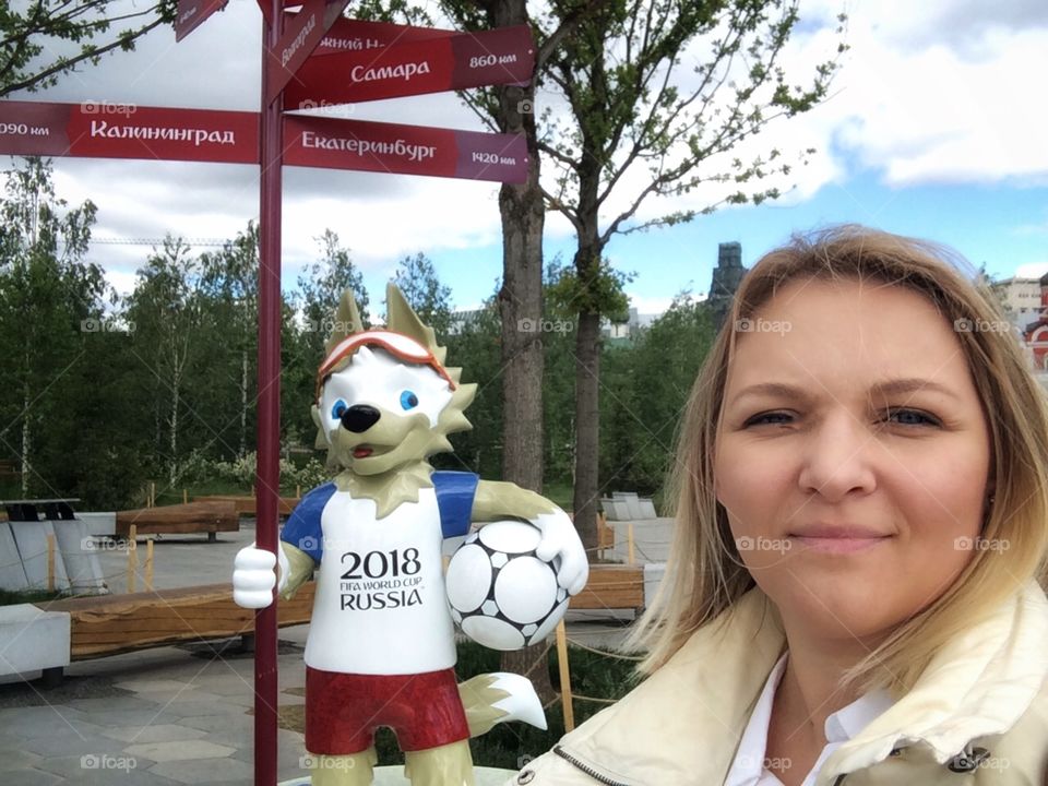 FIFA 2018 Russia football championship symbol in Moscow park Zaryadie, blond woman selfie