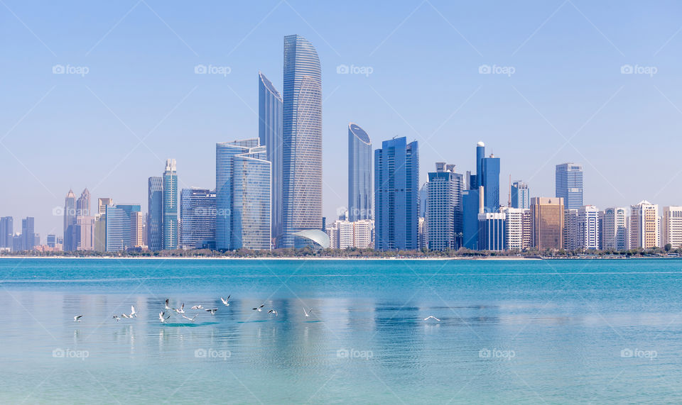 Abu Dhabi cityscape during bright sunny day, view from the seaside