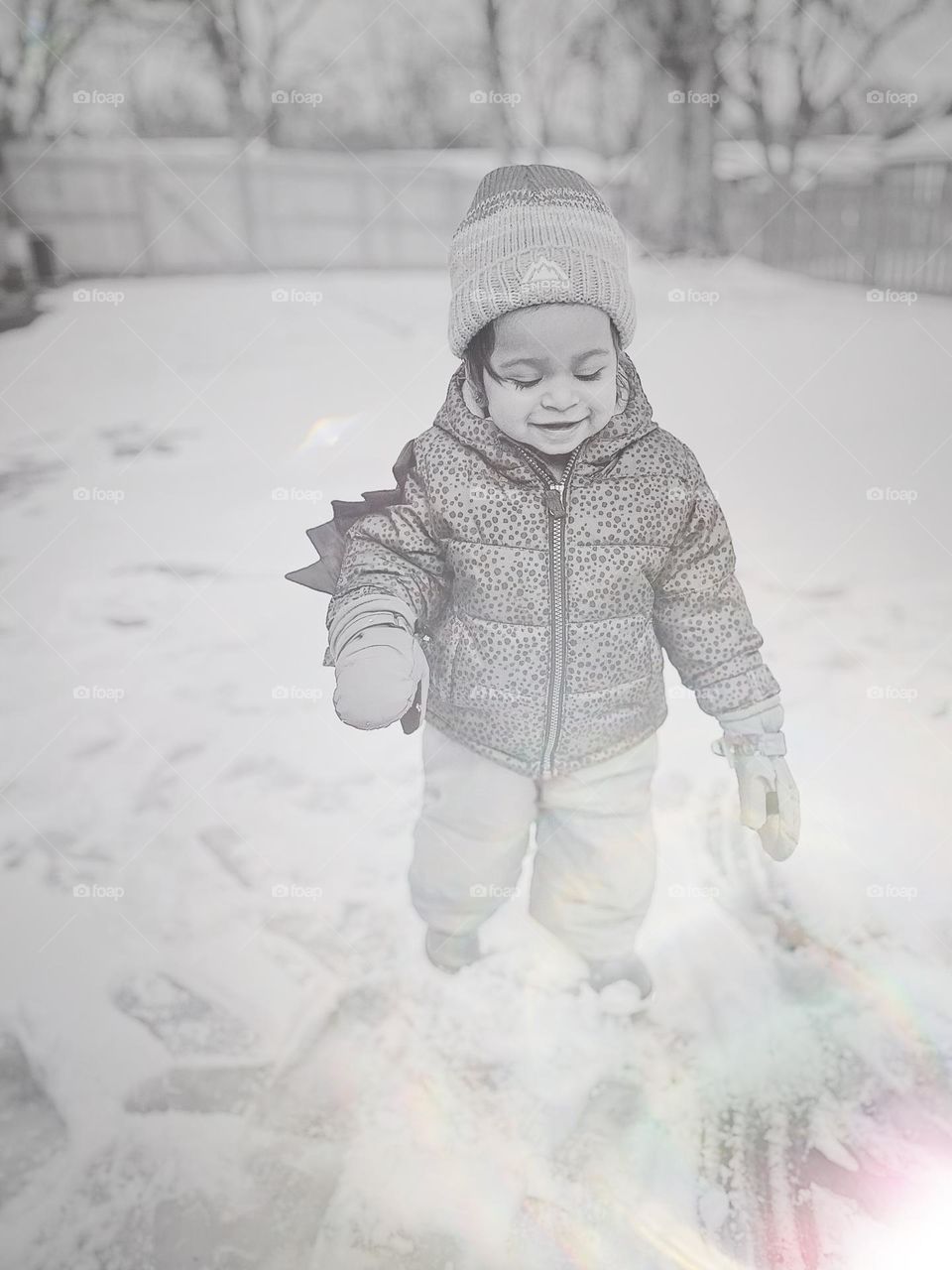 Little girl enjoying the icy artistry, toddler enjoys the winter weather, walking in the snow and ice, icy and snowy conditions 