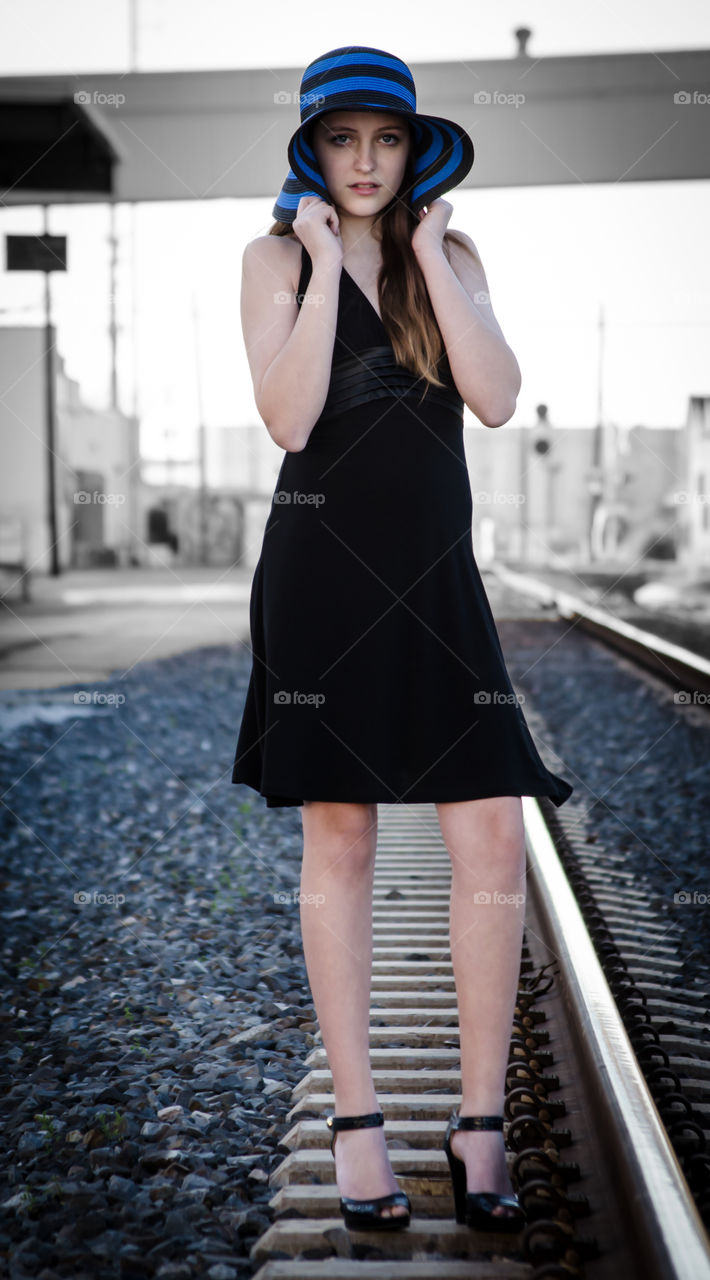 Girl in the blue hat on the tracks