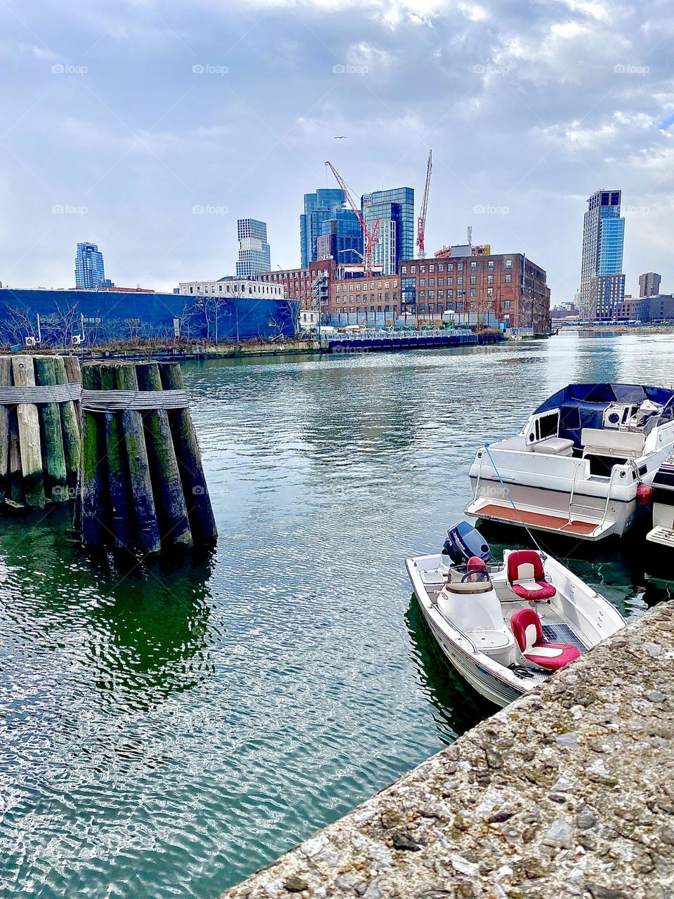 Newtown Creek in Long Island City, Queens, NY with its various different boats photographed from the parking lot underneath the Pulaski Bridge on an overcast day in December 2021. Hypnotic Productions