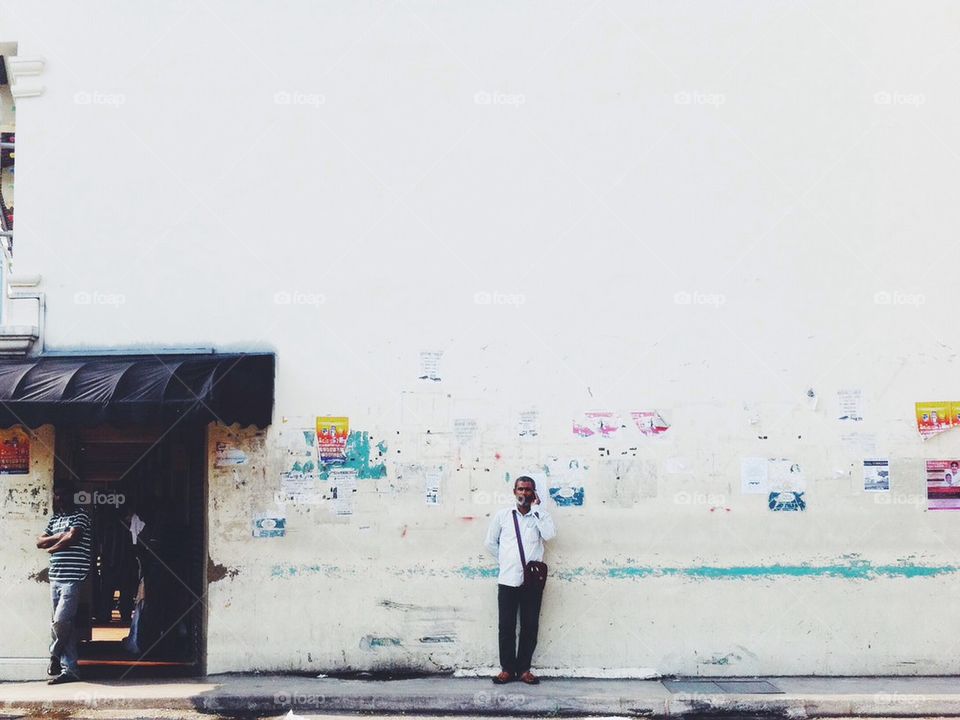 A man in the middle of a big wall