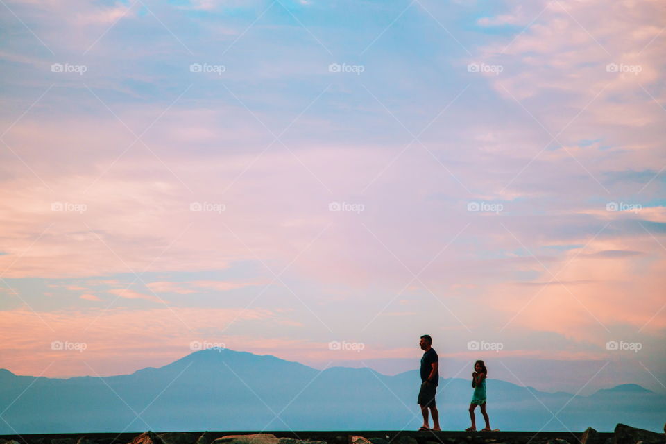 Father and daughter walking on the beach