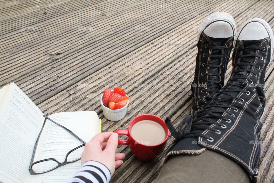 Reading on wooden decking 