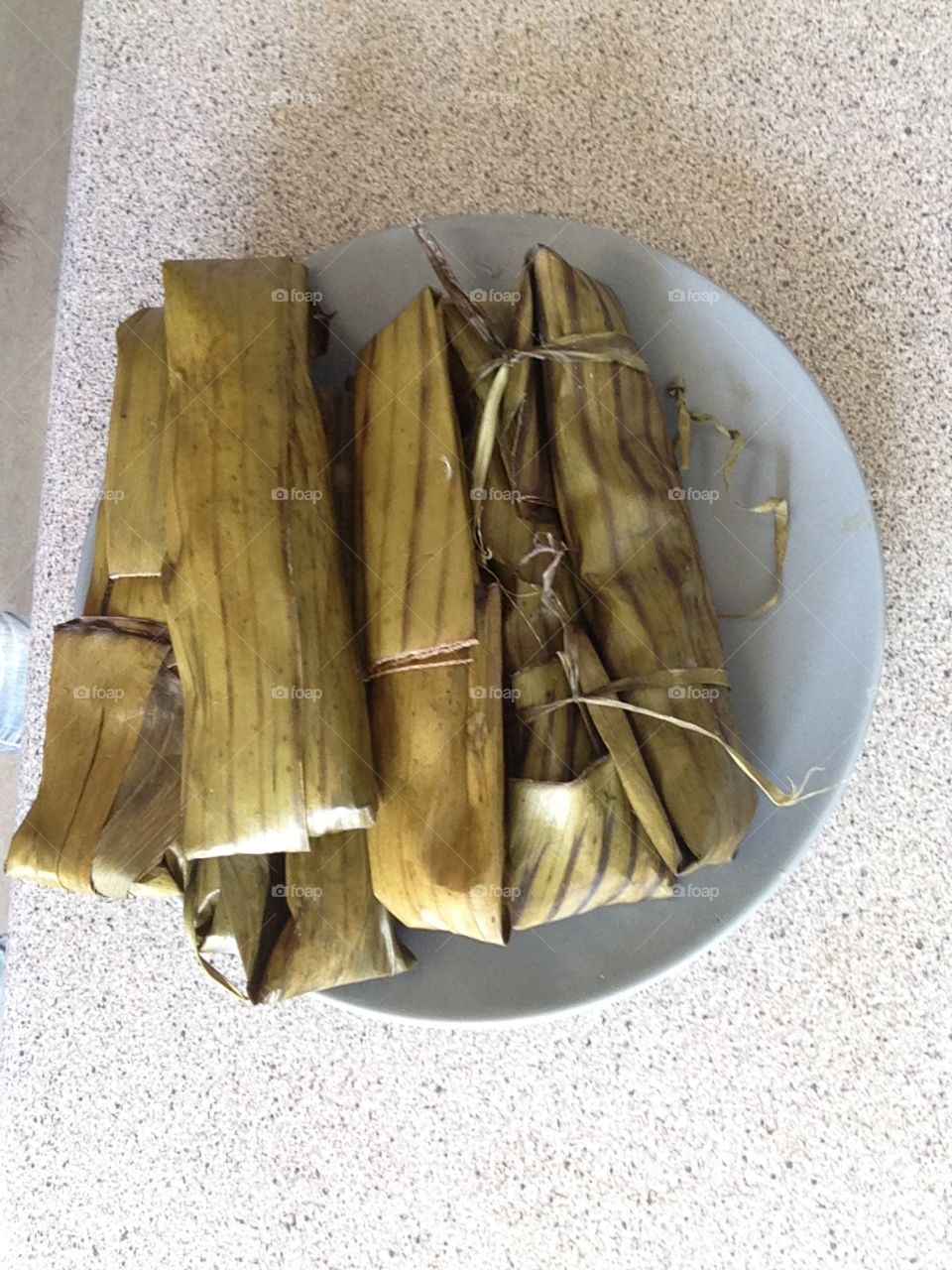 Banana leaves staffed with glutinus rice, very a famous dessert in my country and these is good for coffee and te.