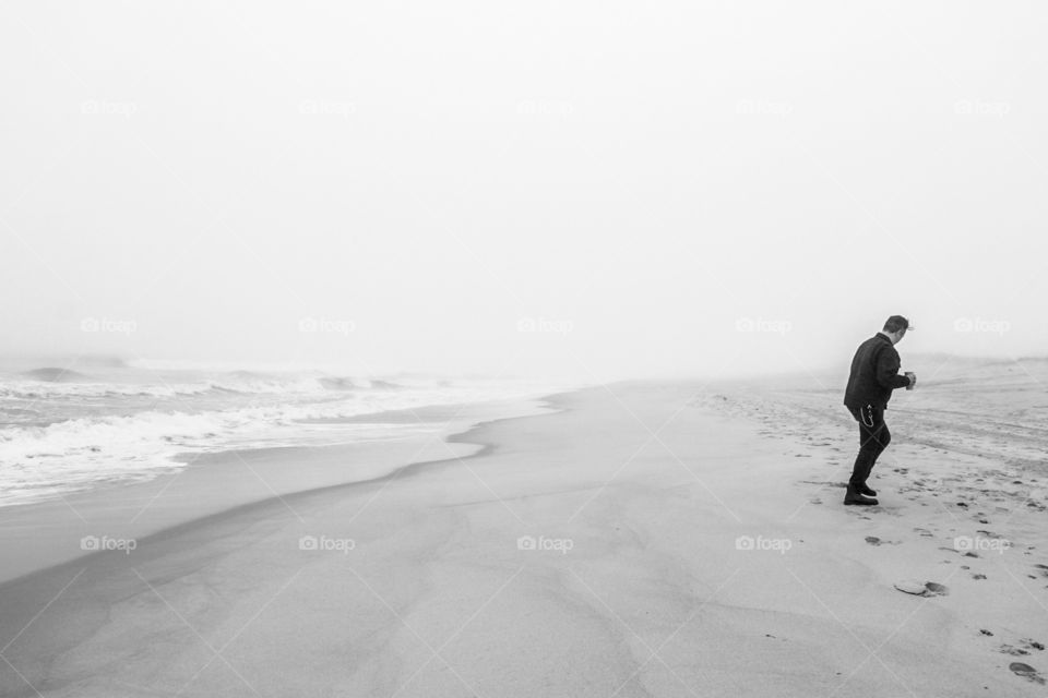 Monochromatic Man Walking From Ocean, Man Walking On Beach With Drink, Black And White Beach Portrait 