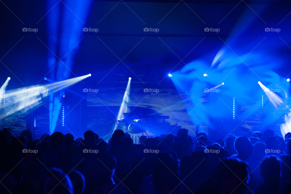 Big nightclub with thousands av people partying with live performance from a DJ.