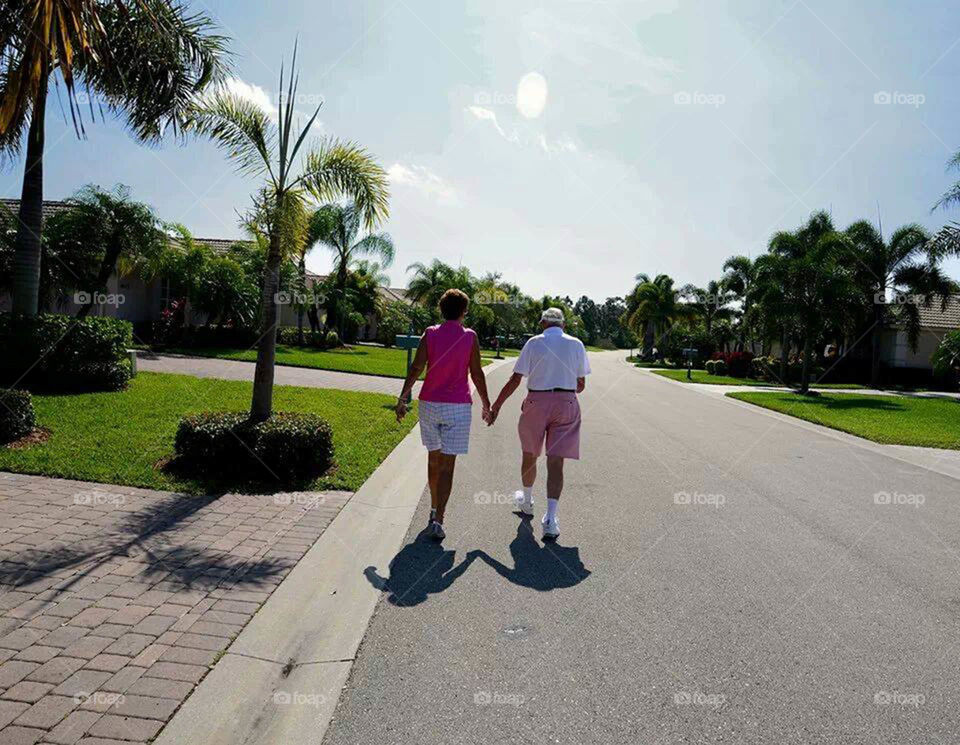 True love. Couple married almost 50 years still hold hands every morning on their walk together