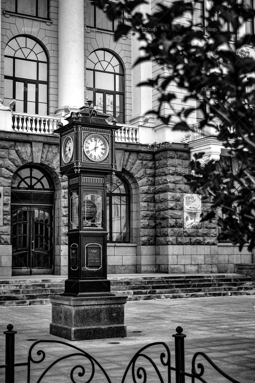 Urban architecture black and white photo. Square and city clock 