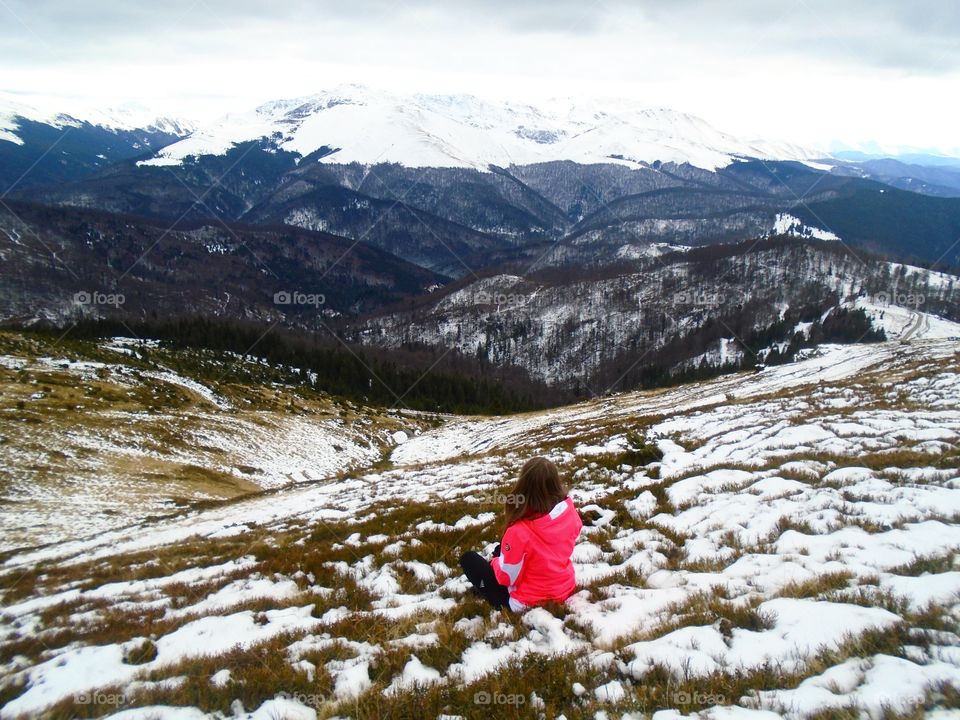 Woman hiking in the mountains in winter