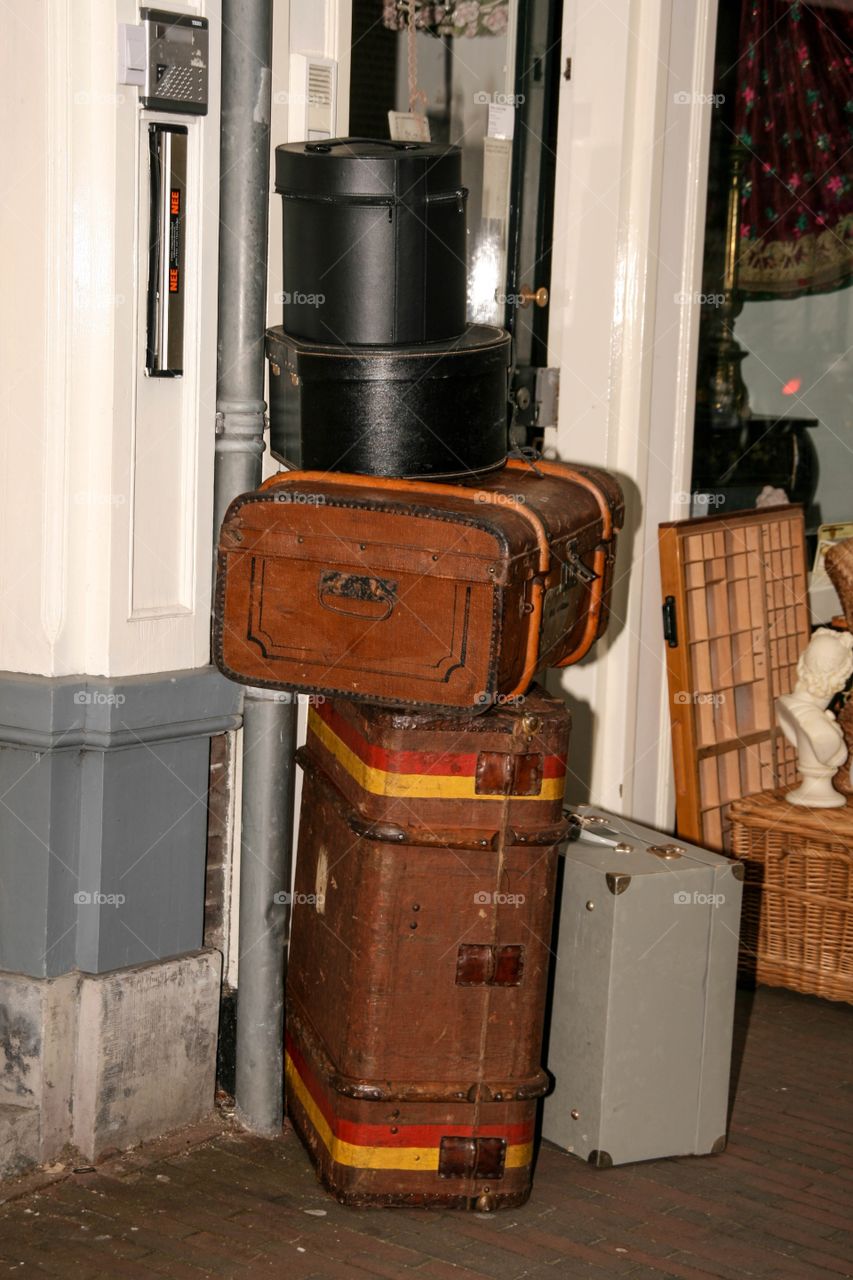 Antique suitcases displayed on the sidewalk