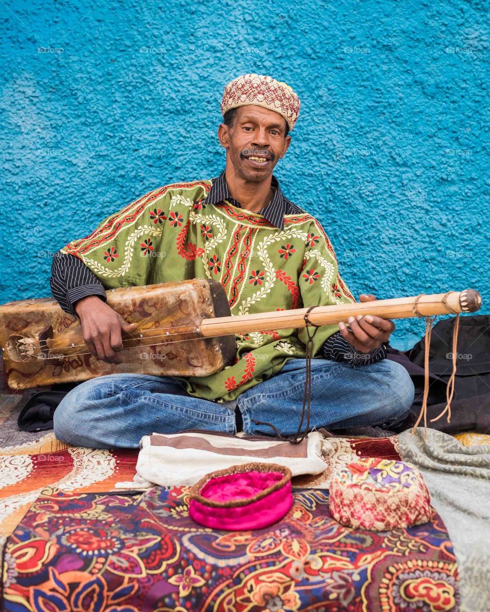 Smiling man playing musical instrument