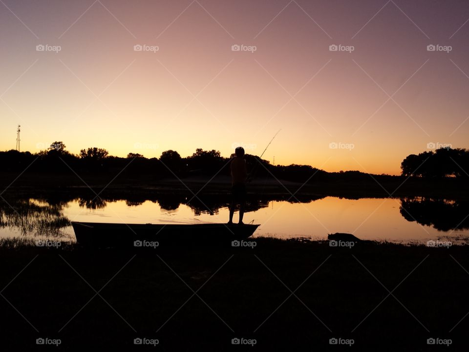 sunset silhouette. evening fishing