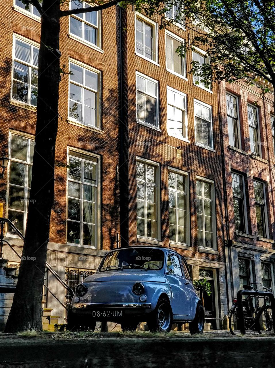 A car parked next to a canal in Amsterdam