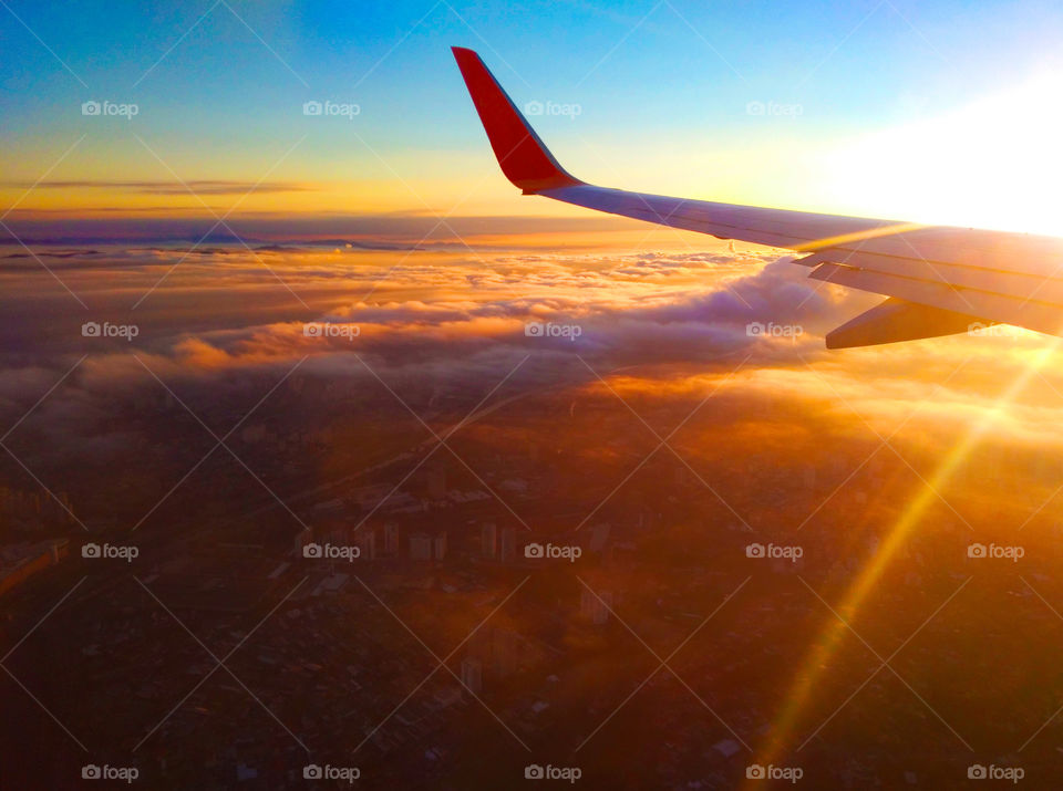 Sun rising and airplane flying over