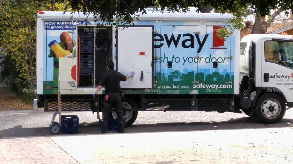 Safeway fresh to your door driver unloading groceries for delivery
