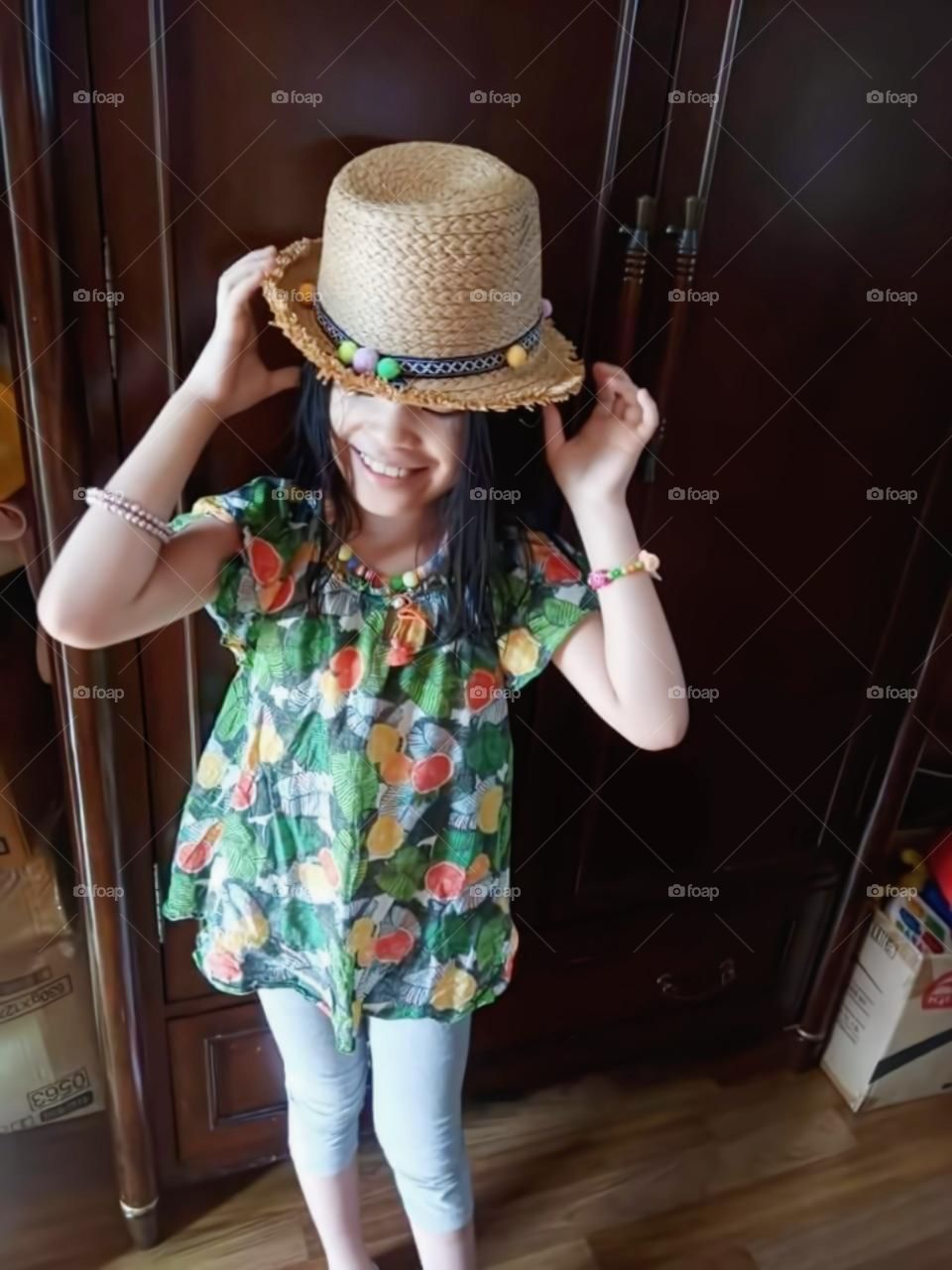 summer weather is good. so she's so excited  and happy wearing her own made hat and to rock outside.