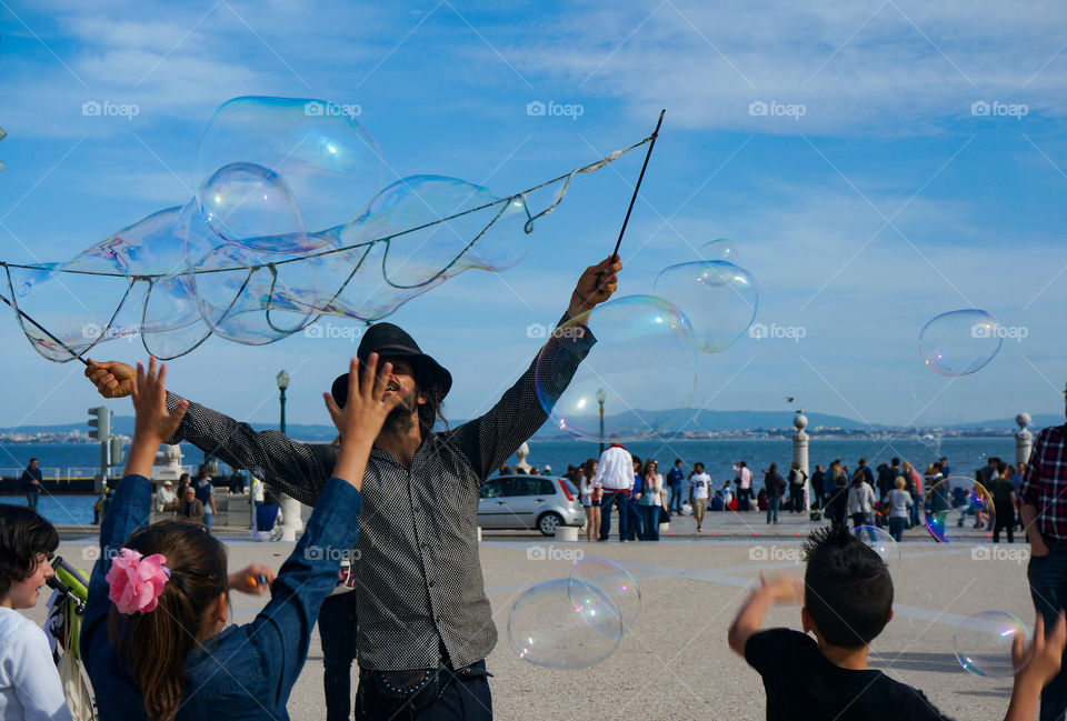 Children having with soap bubbles