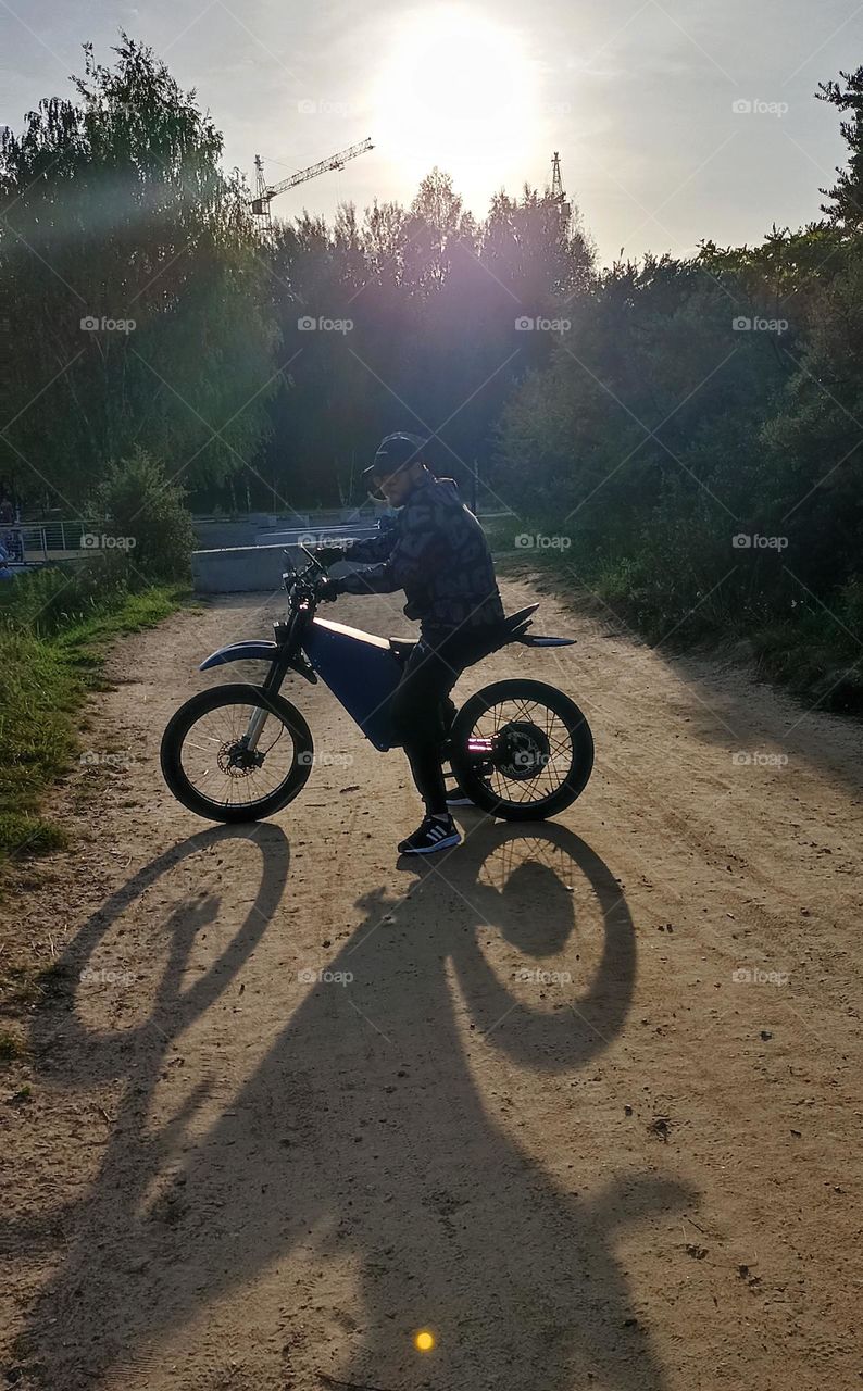 men on a electric motorcycle, summer time