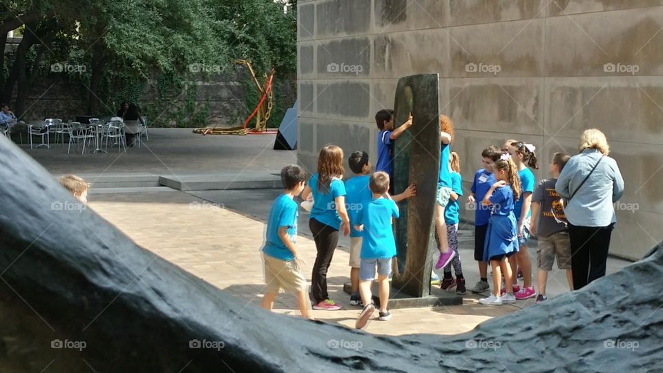 Kids Playing on an outside sculpture at the Dallas Museum of Art