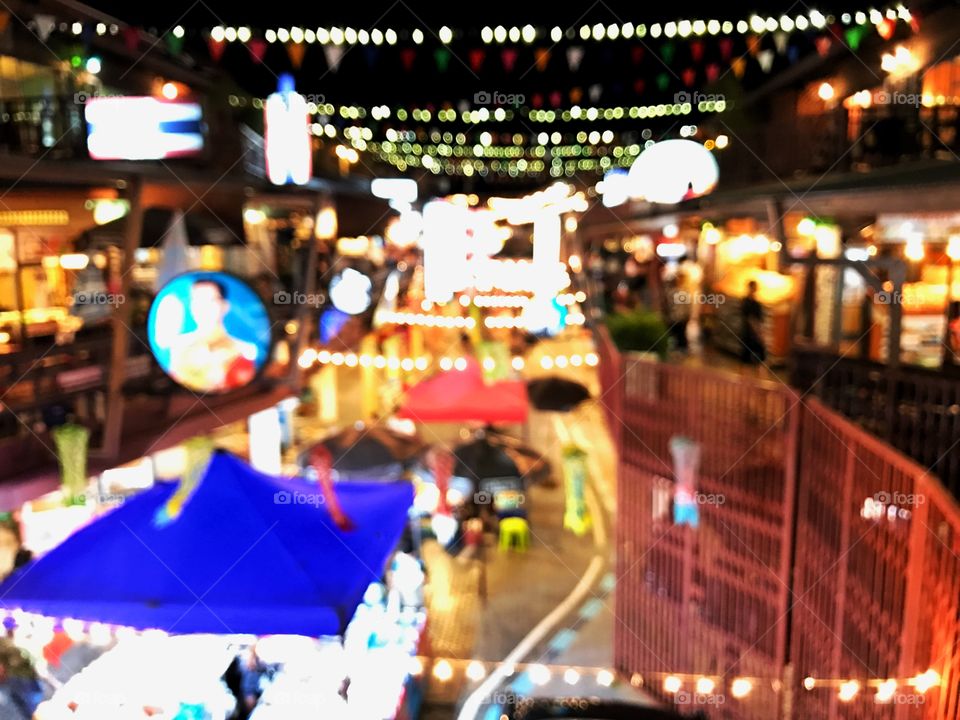 Beautiful bokeh light and blur background in night market in Thailand