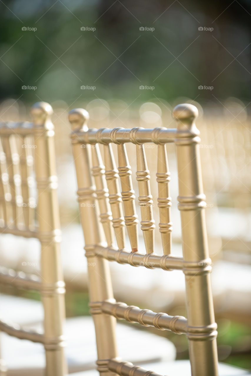Gold chivari chairs in wedding ceremony