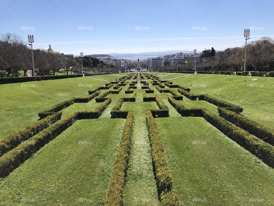 Green labyrinth at the grass with rectangles and a blue sky at the park