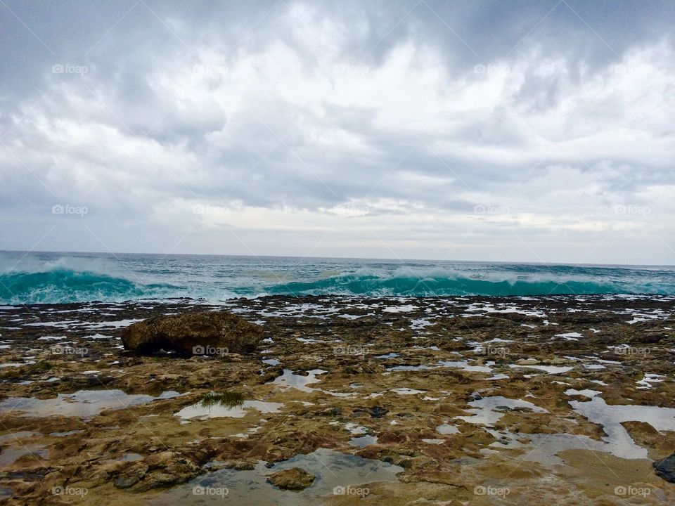 Spewing Water in Kauai. Spewing Pacific water over volcanic rock in Kauai, Hawaii