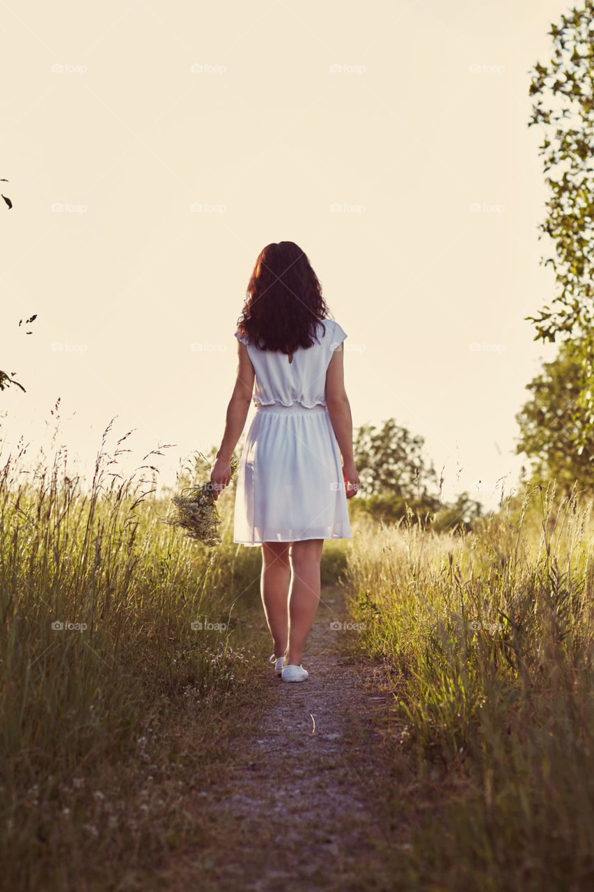 girl walks across the field