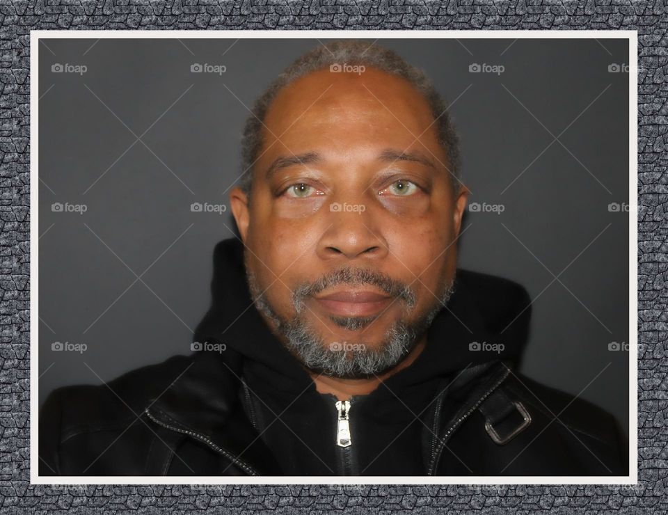 self portrait of a man in a black hooded jacket