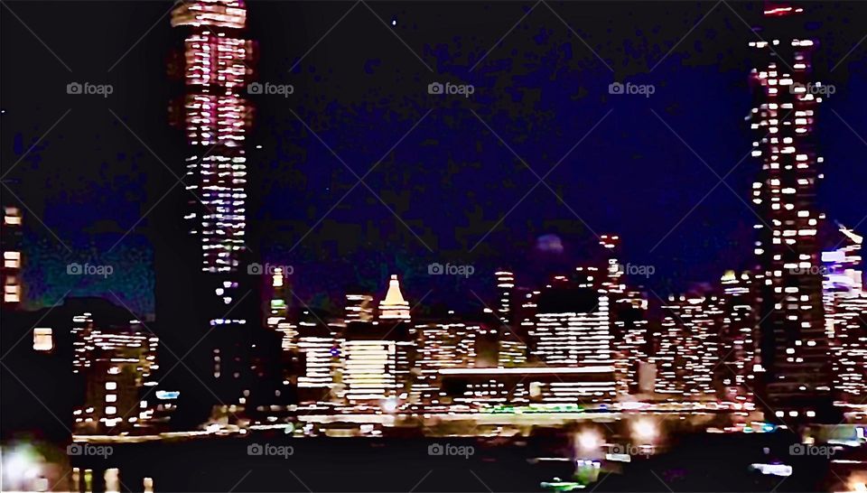 „New York City“ at night as seen from the „Ferry“ that takes commuters across the „East River“ from Queens to Manhattan and vice versa for the price of a subway token which is $ 2.75. 2022 Hypnotic Productions